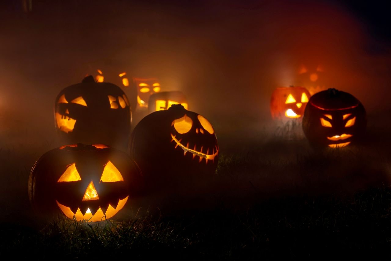 Scary pumpkin carving ideas with a glowing jack-o'-lantern face